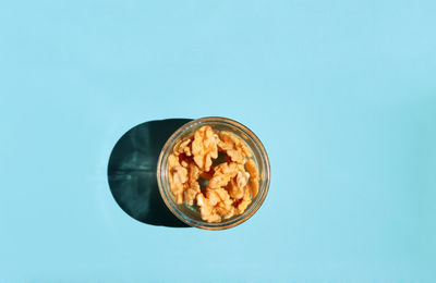 Directly above shot of food in bowl on blue background
