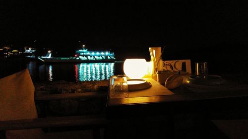 Illuminated candles on table at night