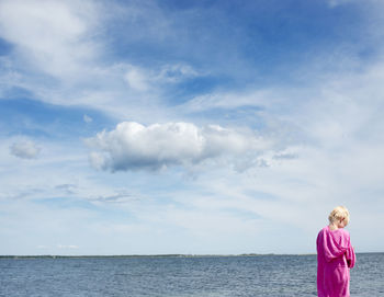 A boy in a bathrobe at the ocean