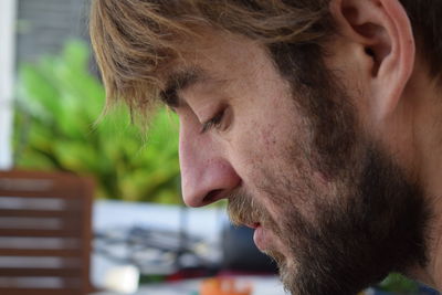 Close-up of thoughtful bearded man looking down