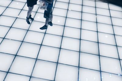 Low section of people on tiled floor
