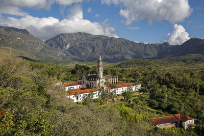 High angle view of townscape and mountains against sky