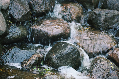 High angle view of stream flowing through rocks