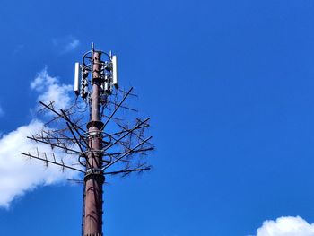 Low angle view of communications tower against sky