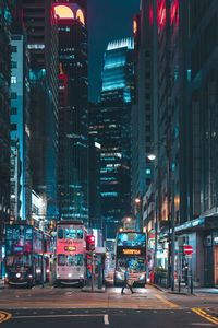 Illuminated city street and buildings at night