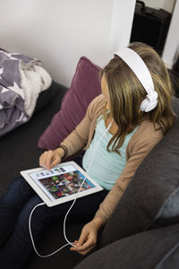 Girl listening music on digital tablet at home