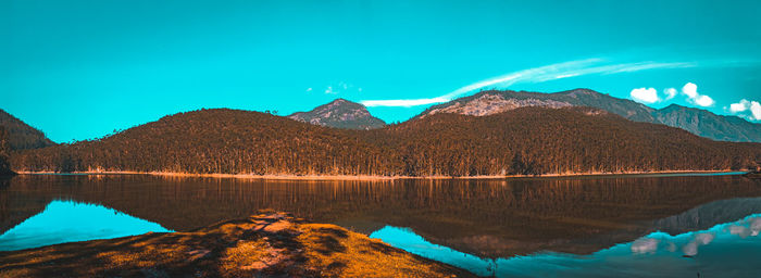 Scenic view of lake against clear blue sky