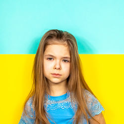 Sad girl on the background of the ukrainian flag. the concept of peace in ukraine. 