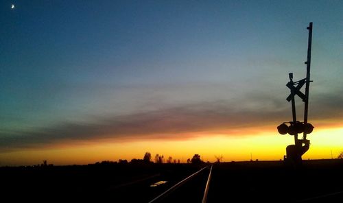 Silhouette of road against sky during sunset