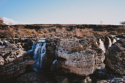 Panoramic view of rock formations against clear sky