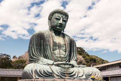 Low angle view of statue against sky