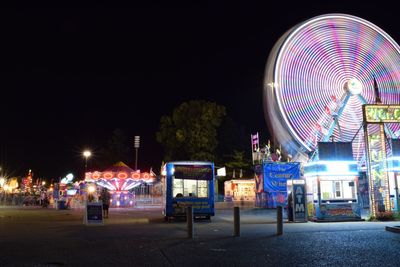 Illuminated ferris wheel at night