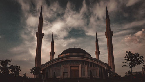 Low angle view of building against cloudy sky