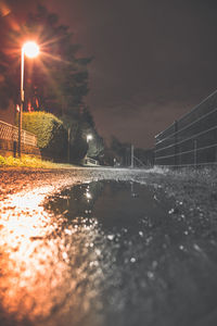 View of river along illuminated road