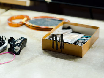 High angle view of hair clip by hairpins on table