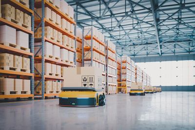 Widely used parcel sorting robot system using agv with tilt tray.3d rendering