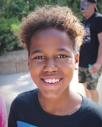 Portrait of smiling boy standing outdoors