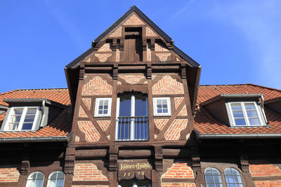 Low angle view of house against blue sky