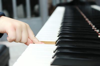 Cropped image of man holding piano