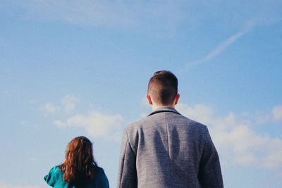 Rear view of people looking at sky