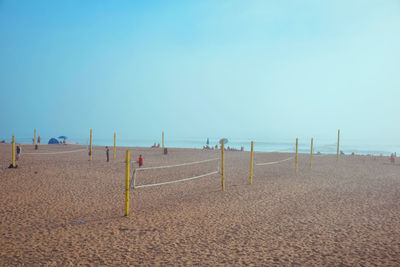 Scenic view of beach against clear blue sky