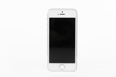 Close-up of telephone booth against white background