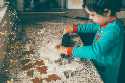 Mother and son engage in delightful holiday baking, crafting christmas gingerbread