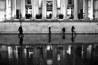 Reflection of men on water
