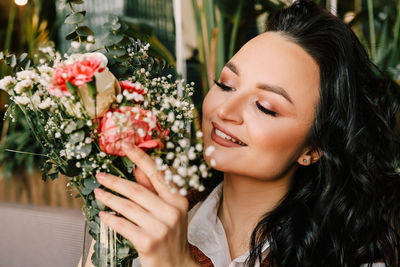 Portrait of smiling woman with flower bouquet