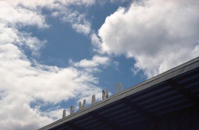 Low angle view of building against cloudy sky