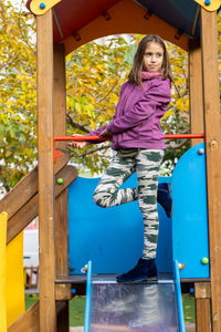 Full length of girl standing on jungle gym