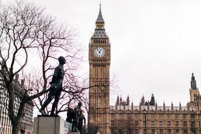 Clock tower amidst buildings in city