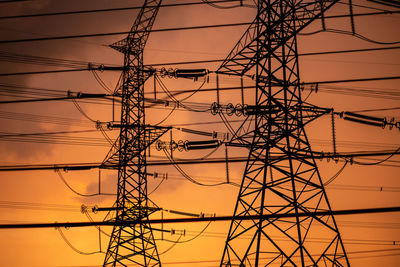 Low angle view of electricity pylon against sky