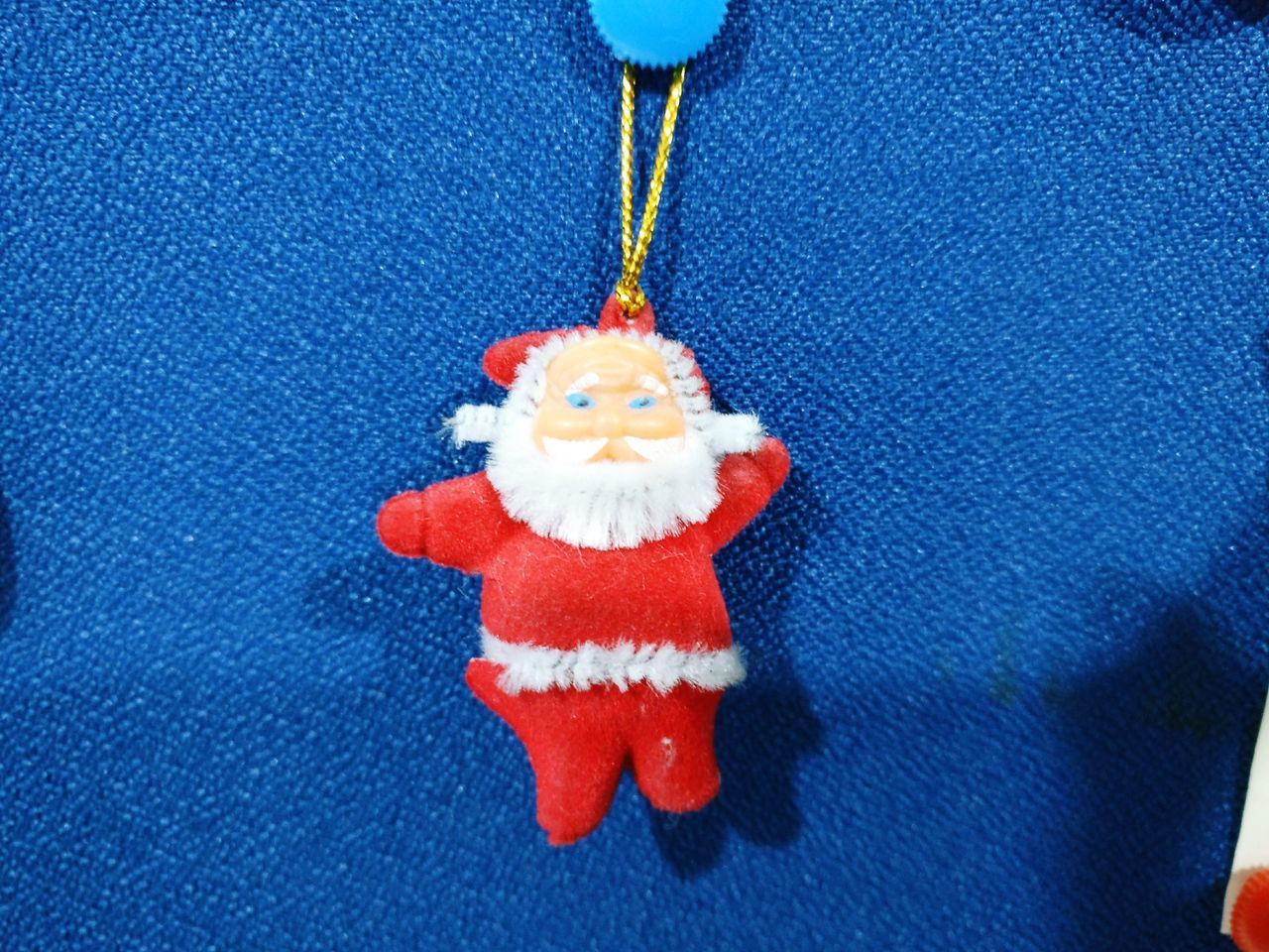 CLOSE-UP OF CHRISTMAS DECORATIONS HANGING ON PAPER