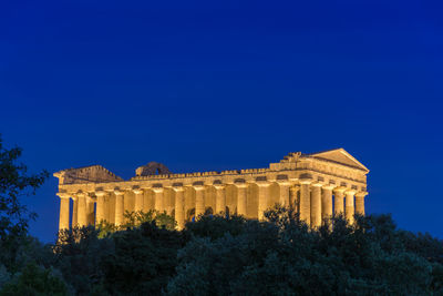 Low angle view of historical building against blue sky