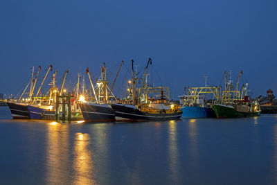 Fishing boats in the harbor from lauwersoog in the netherlands at night