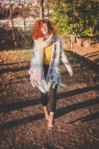 Portrait of smiling young woman with autumn leaves