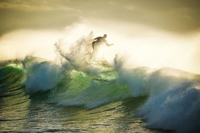 View of man surfing on wave