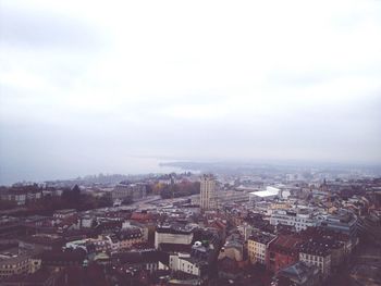 Cityscape against cloudy sky