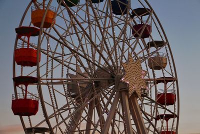 Low angle view of ferris wheel against sky