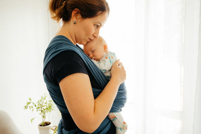 Happy mother and woman with arms raised