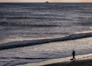 High angle view of man standing on beach