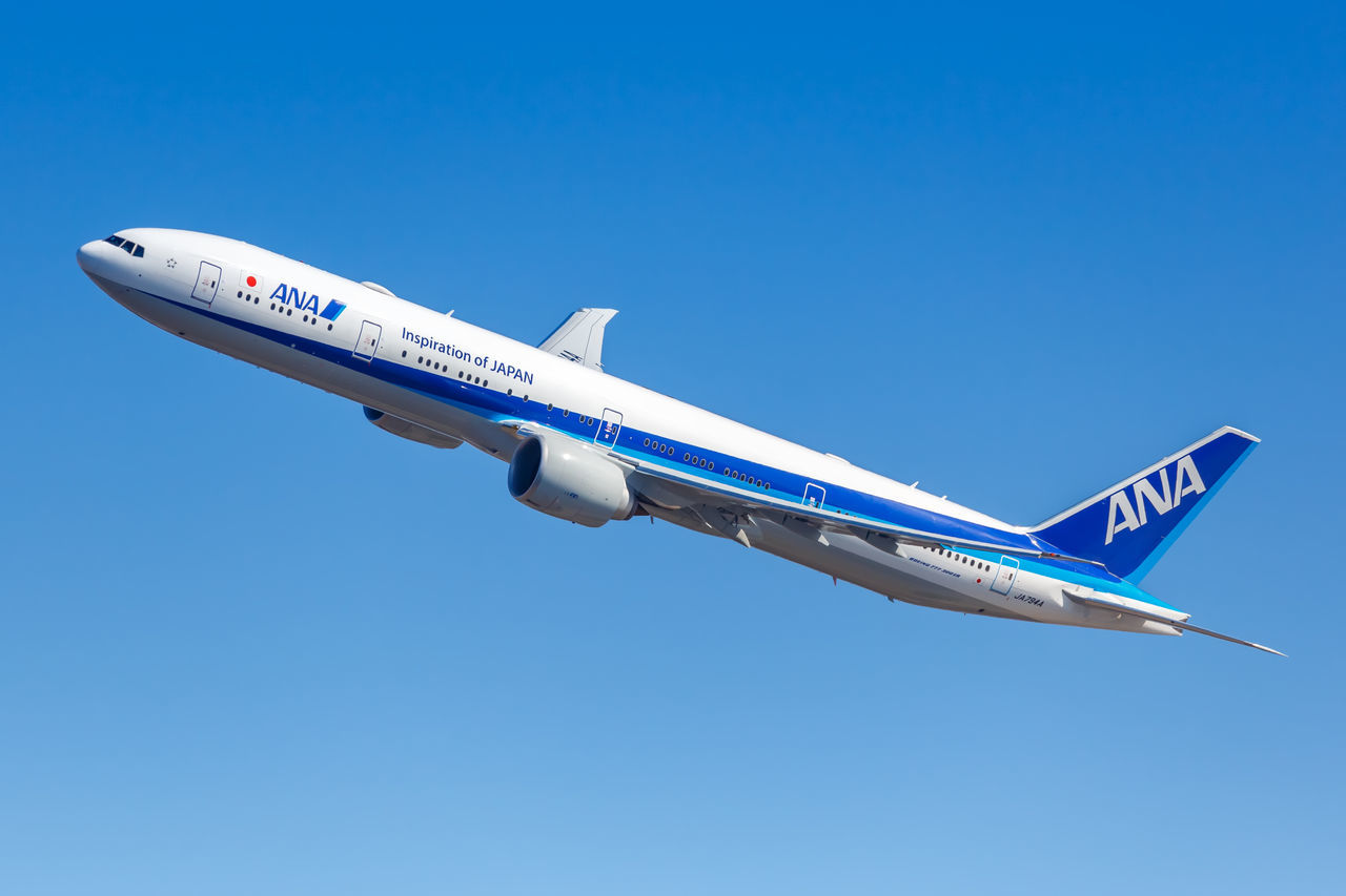 LOW ANGLE VIEW OF AIRPLANE FLYING AGAINST CLEAR SKY