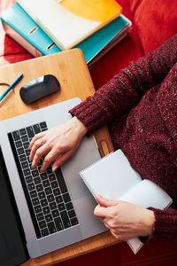 Midsection of woman using laptop