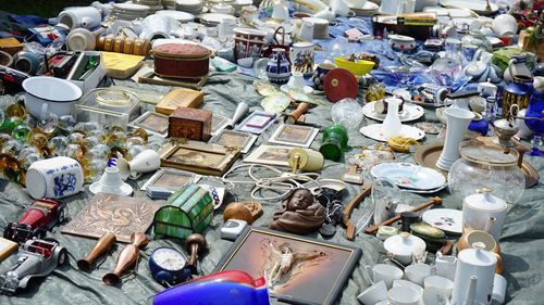 High angle view of various antiques displayed for sale at market stall