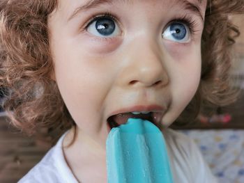 Close-up portrait of a girl eating ice cream