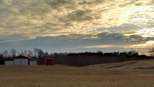 Scenic view of field against cloudy sky