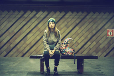 Portrait of woman sitting on bench