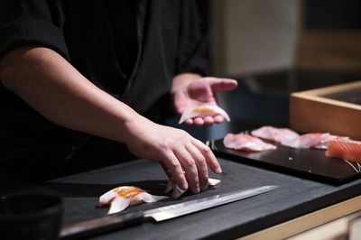 Midsection of man preparing food on table