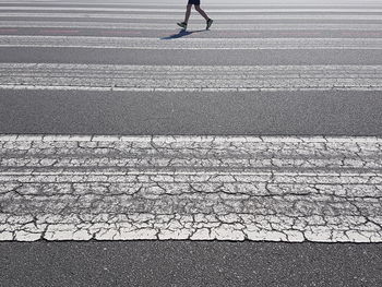 Low section of person crossing road